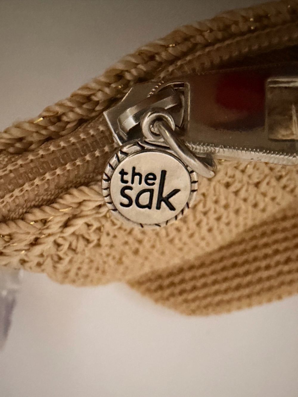 The Sak Cream Woven Zip Pouch with Silver Logo Charm